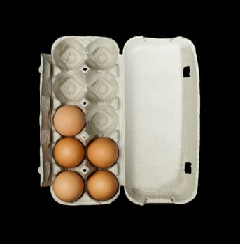 Eggs box and aggs inside. Isolated on black background.