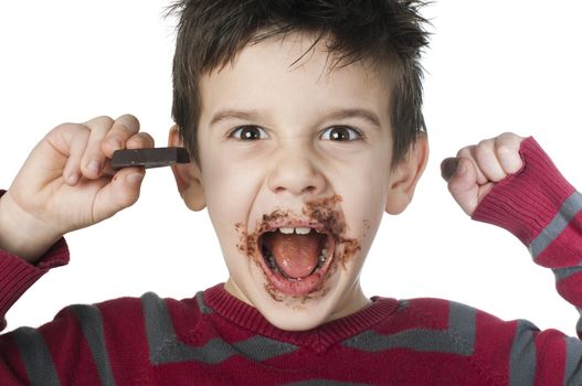 Smiling kid eating chocolate. Smeared stained with chocolate lips. White isolated