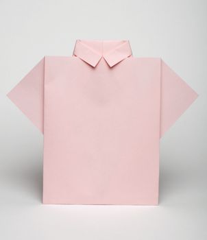 Isolated paper made pink shirt. Folded origami style