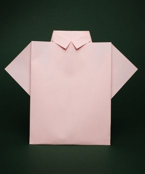 Isolated paper made pink shirt. Folded origami style