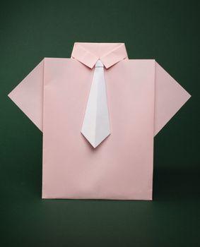 Isolated paper made pink shirt with white tie.Folded origami style