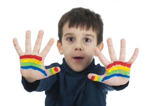Boy hands painted with rainbow colors. White islated smiling child