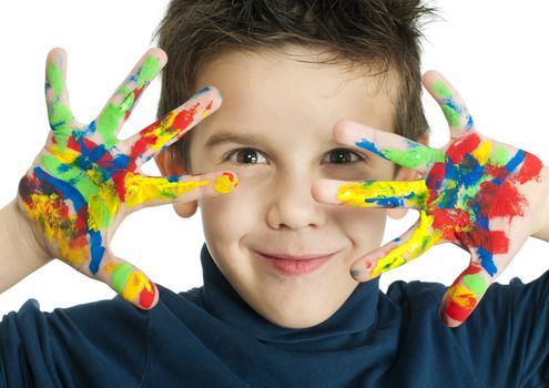 Boy hands painted with colorful paint. White islated smiling child