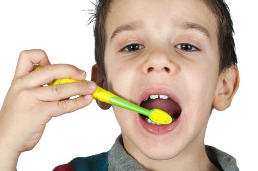 Boy brushing his teeth. White isolated