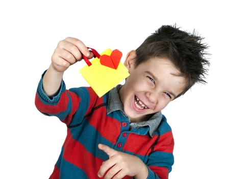 Boy who laughs and holds small shopping bag with heart. White copy spice