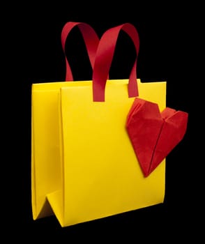 Yellow and red shopping bag with red heart.