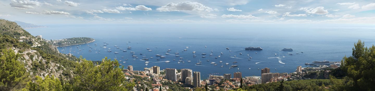 Panoramic photo of Monaco.Castle, big ship, Monte Carlo Casino and yachts in the bay.
