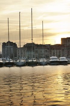 Yachts moored in Cannes at sunset. Cannes bay