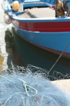 Fishing Boat and blue nets in the foreground