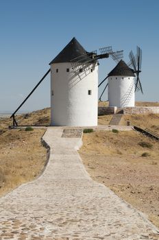 White ancient windmills. Blue sky background