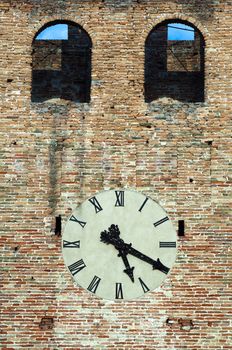 Antique clock on a building. Ancient brick wall