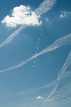 Traces of planes and clouds in the sky.