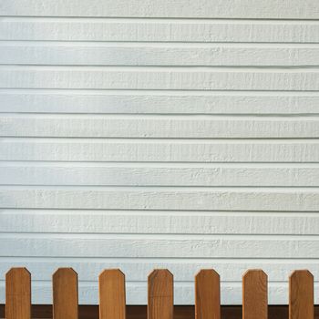 Wooden decorative fence and white wall