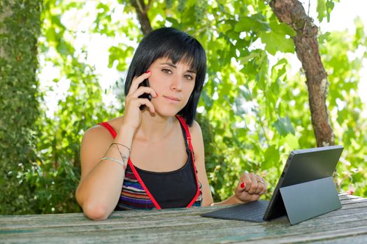 casual woman working with a tablet pc, outdoor