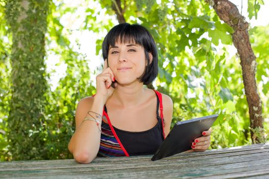 casual woman working with a tablet pc, outdoor