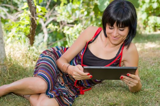 casual woman working with a tablet pc, outdoor