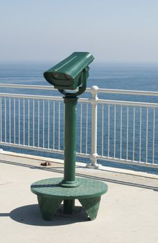 Green tourist telescope. Sea view and sky