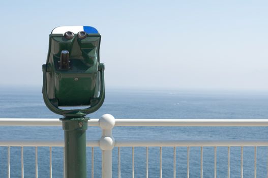 Green tourist telescope. Sea view and sky