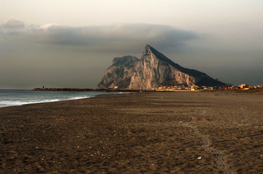 The rock of Gibraltar and the sea. Early morning. View from Spain beach