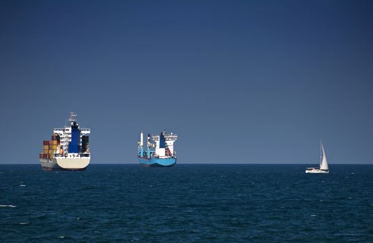 Commercial container ships on blue sky