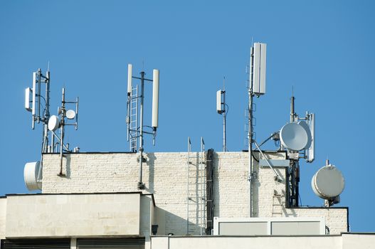 GSM transmitters on a roof of white administrative building. Close up