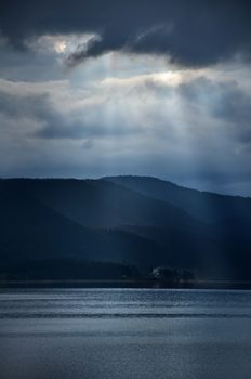 Vertical sunset at dam. Blue colors