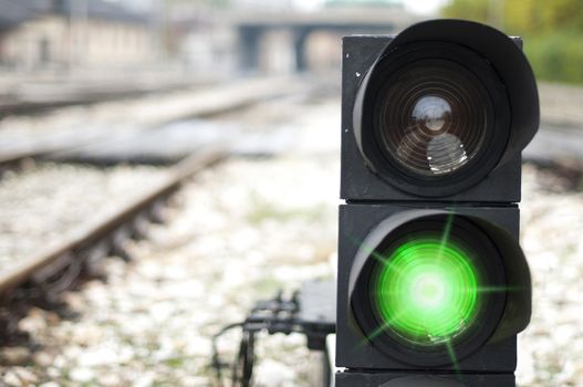 Traffic light shows red signal on railway. Green light