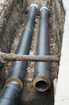 Installing pipes for hot water and steam heating. City heat pipeline