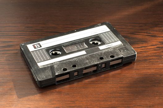 Audio tape cassette. Wooden background 