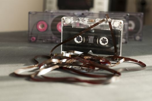 Audio tape cassette with subtracted out tape. Old broken cassette