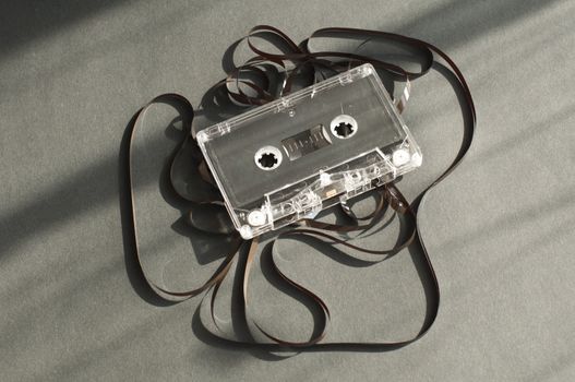 Audio tape cassette with subtracted out tape. Old broken cassette