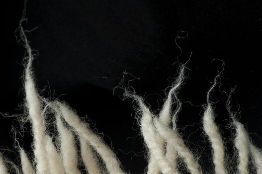 White wool fibers closeup. Black isolated