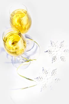 Two glasses of wine and snowflakes on a white background. Holiday concept