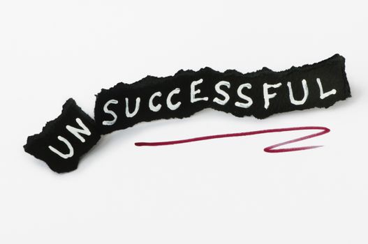 Success text over black paper. Unsuccessful and successful conception