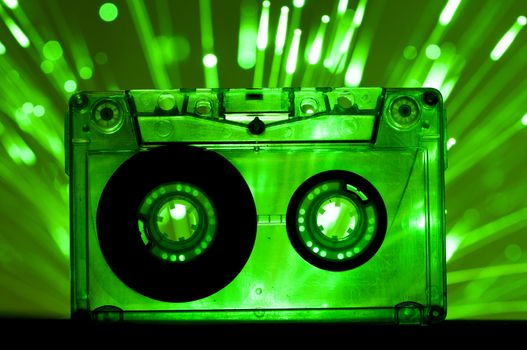Transparent Cassette tape and green color disco lights background