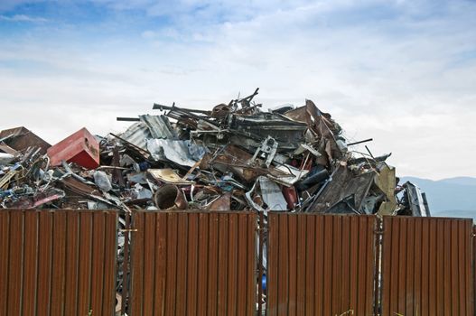 Scrap metal on blue sky background