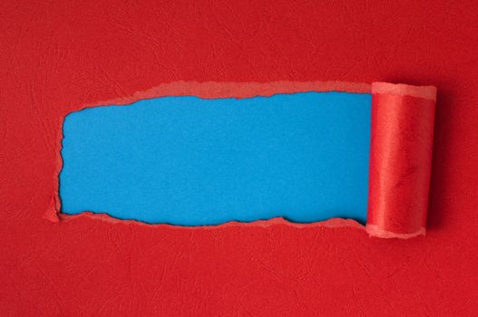Red torn paper with blue space for text or other content