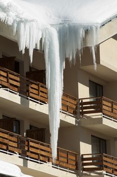 Icicles on window. Wooden house windows