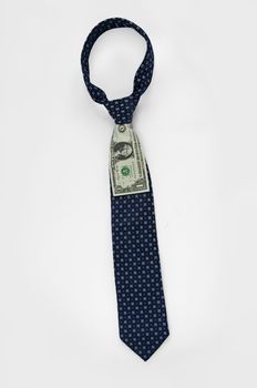 Closeup of a blue business tie with one dollar