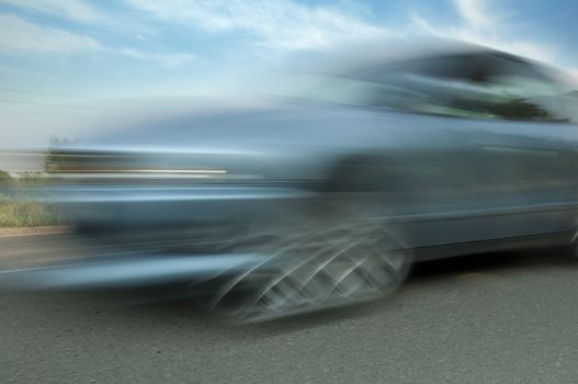 High speed blurred car with blue sky