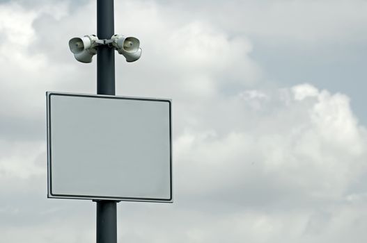 Speakers and plate on blue sky background