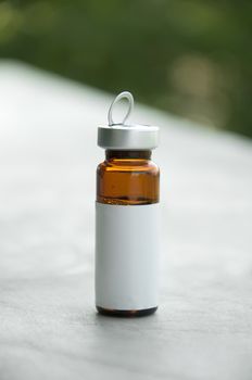 Small bottle for medicines. With white empty label