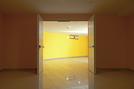 Two opened doors and yellow walls