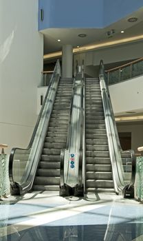Shop escalator in shopping center. Vertical photo