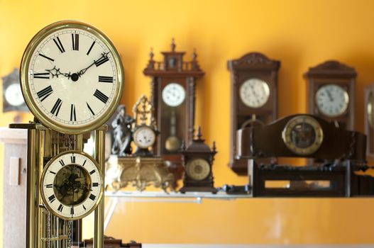 Old antique clocks close up and blurred background clocks