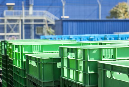 Green plastic crates. Blurred blue background