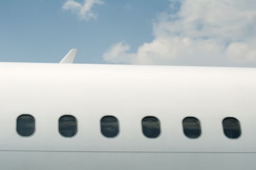 Windows of an airplane outside. White color plane