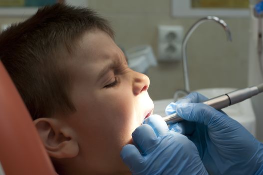 Child in a dentist's chair in cabinet