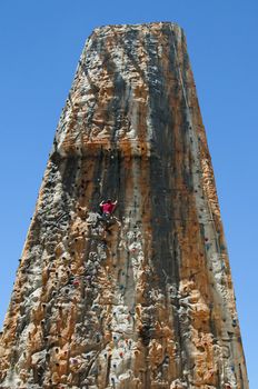 Boy on a big climbing wall, on vertical