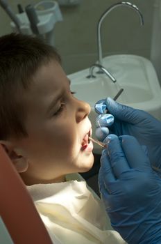 Child in a dentist's chair in cabinet